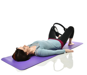 Woman exercising doing postnatal workout. Female fitness instructor working out with a rubber...