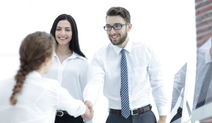 young business woman shaking hands with a colleague