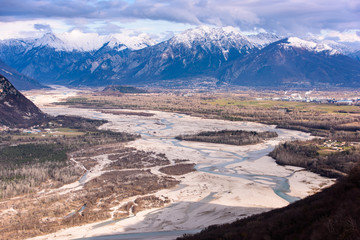 The slow flow of the Tagliamento river cradled by its mountains.