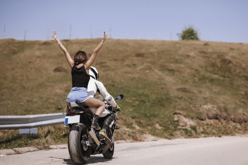 Plakat Beautiful couple traveling with a sports motorcycle