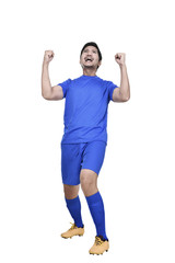 Excited asian male footballer posing celebrate