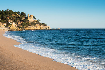 Naklejka na ściany i meble Landscape of Lloret de Mar Castle and its beach in a sunny afternoon, Spain.