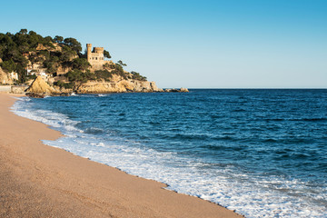 Obraz premium Landscape of Lloret de Mar Castle and its beach in a sunny afternoon, Spain.