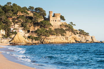 Fototapeta na wymiar Landscape of Lloret de Mar Castle and its beach in a sunny afternoon, Spain.