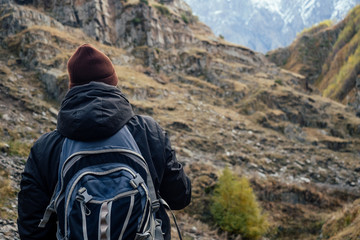 handsome man with a red beard and a backpack travels