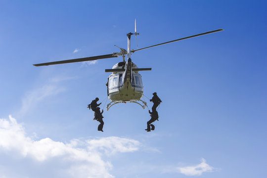 Special forces in helicopter with blue sky on background