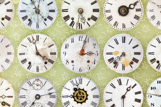 Clock faces in front of retro wallpaper