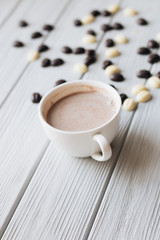 White cup of coffee on wooden table