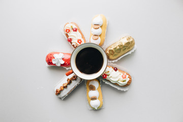 Assorted delicious sweets on grey background