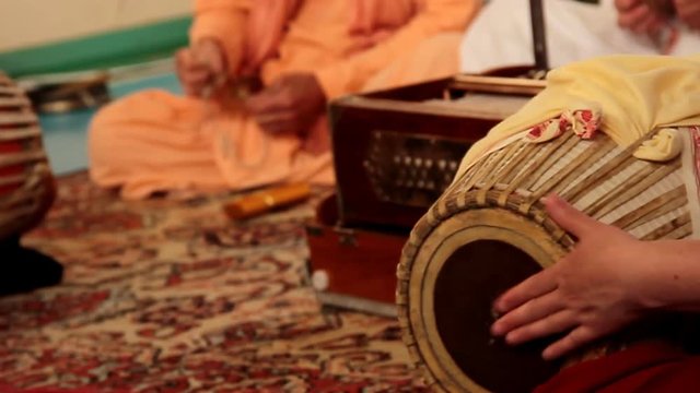 Krishna plays on Indian musical spiritual instruments