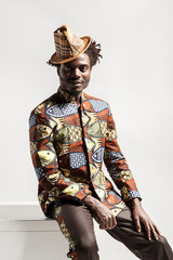 Happiness fashion african man looking at camera and sit