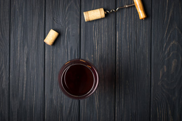 Glass of red wine on gray wooden table. View from top