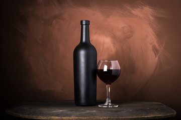 Red wine bottle on a wooden brown background