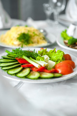 Vegetable mix, vegetable slicing, cucumbers, tomatoes, cheese, parsley, plate, serving, restaurant.