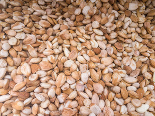 Background from a dry kernels of walnuts. Close-up texture of heap of unshelled walnuts, overhead view. Healthy food.