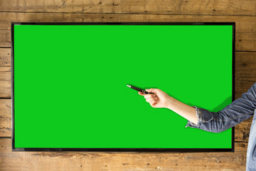Blank TV screen for presentations. Woman's hand pointing to screen