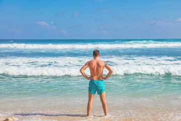 Fototapeta na wymiar Man enjoying on a tropical ocean beach.