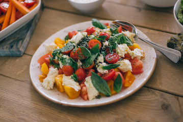 Green salad with vegetables on the wood table