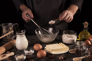 Set of products and process of kneading dough for baking, isolated on black