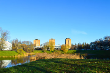 Urban landscape with modern buildings and pond.