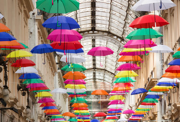 Colorful and beautiful umbrellas hanging in the city street decoration in genova (genoa) italy.