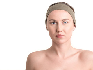 Beautiful young woman's face with clean skin - isolated on white.