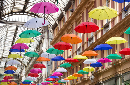 Colorful and beautiful umbrellas hanging in the city street decoration in genova (genoa) italy.