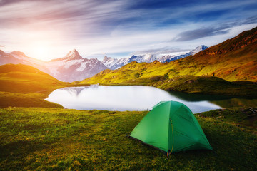 Alpine valley glowing by sunlight. Location Bachalpsee in Swiss alps, Grindelwald.