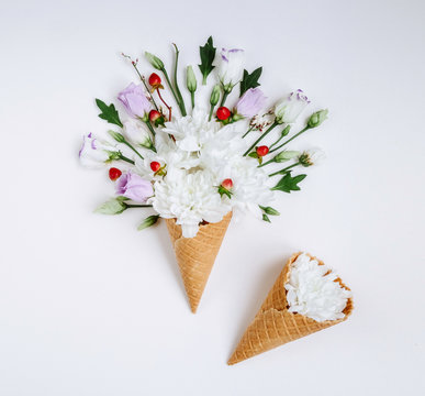 Lovely bouquet flower in ice cream cone on white background. Floral arrangement, flat lay styling. Top view.