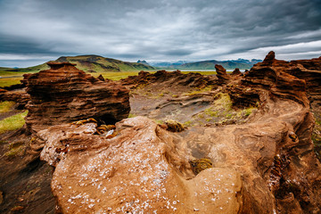 Fototapeta na wymiar Sandy rocks with by magma formed by winds. Location place Sudurland, Iceland.