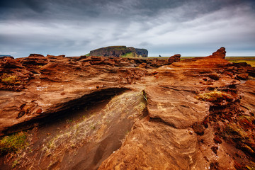 Sandy rocks with by magma formed by winds. Location place Sudurland, Iceland.