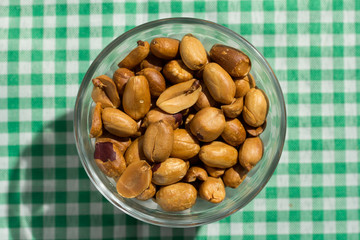 Peanuts on bowl and plaid green table. Food of Festa Junina, a typical brazilian party.