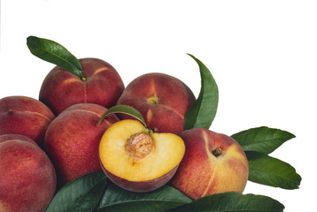heap of red peaches with some leaves, on white background
