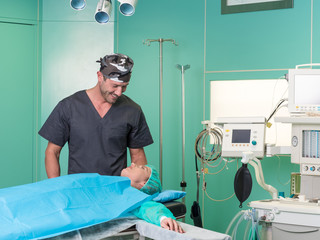 Young surgeon and his patient in operatory room before surgery.