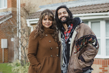 Portrait of a happy mid adult man and his mother on the driveway of their home.