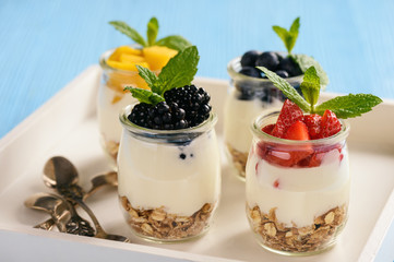 Natural yogurt with muesli, mango and berries.