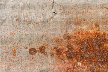 Rusty steel background. Texture of dirty and worn iron plate with holes, chemical reaction.