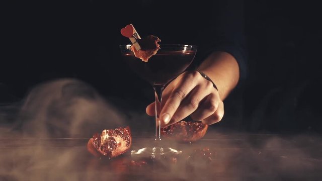 Barman serves a cocktail at the bar