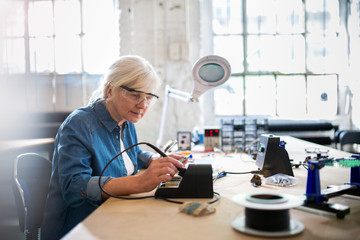 Senior woman in electronics workshop
