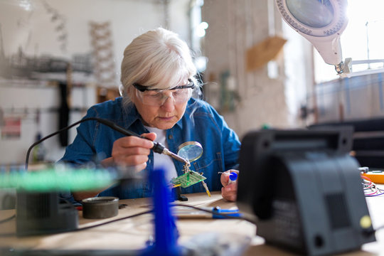 Senior woman in electronics workshop
