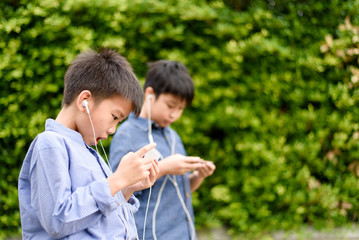 Young Asian boy play game on smartphone