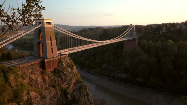 Camera slides past tree with the Clifton Suspension Bridge behind. Shot on a beautiful spring evening 