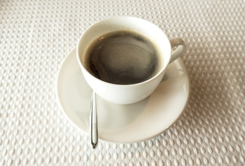 cup of coffee over white table background