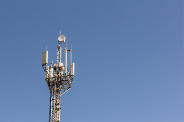 cell tower transmitting signals of mobile phone and Internet against the blue sky