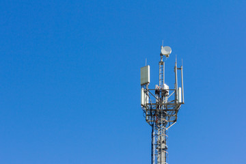 cell tower transmitting signals of mobile phone and Internet against the blue sky