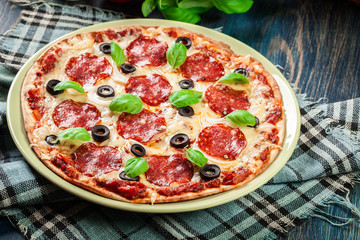 Pizza pepperoni with olives served
