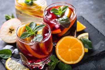 Sangria with fruit, ice and mint in glass. 