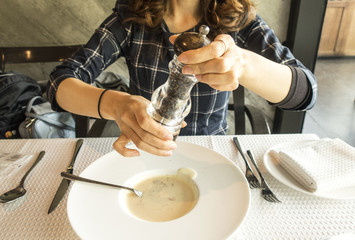 Hand holding a bottle of pepper isolated on white background,pepper shaker