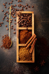 Food background with three kinds of coffee: beans, milled, instant in wooden box on old concrete...