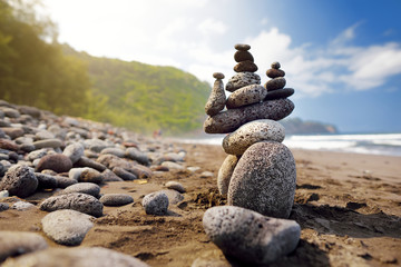 Stack of stones balanced on rocky beach of Pololu Valley, Big Island, Hawaii